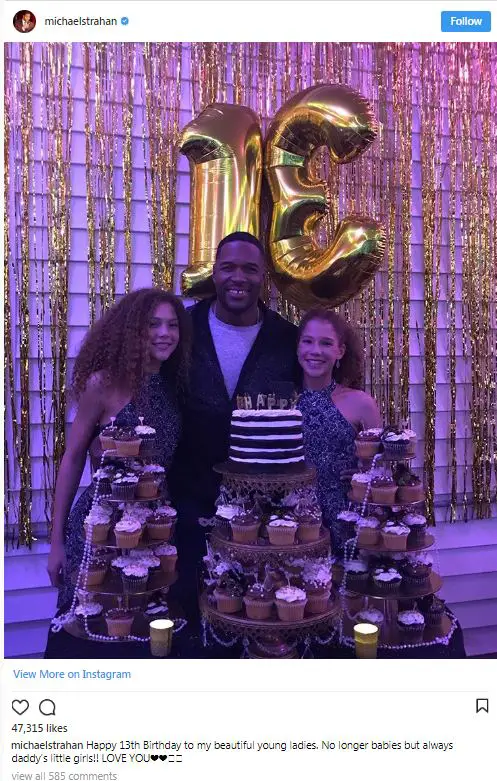 Michael Strahan celebrating his twin daughters