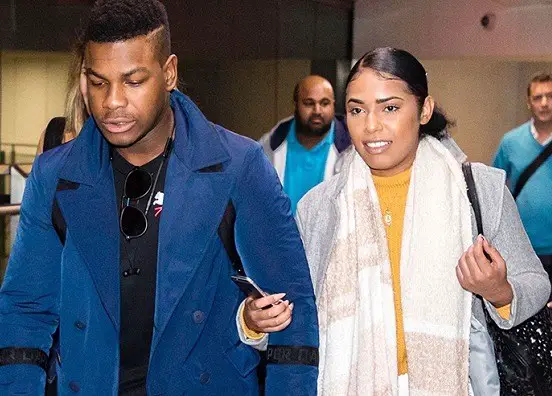  John Boyega arrives in the UK with mystery woman and alleged girlfriend