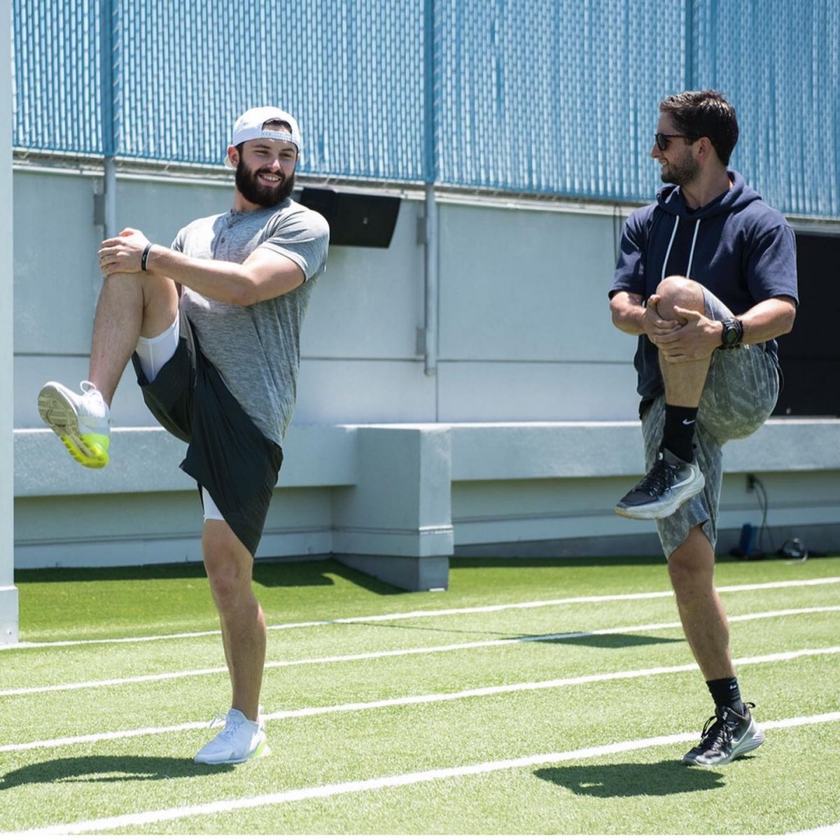 Baker Mayfields Stretching with His Brother on The Track Field 