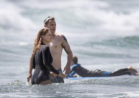 Danielle Cormack with her shirtless partner Adam Anthony at Piha Beach on A...