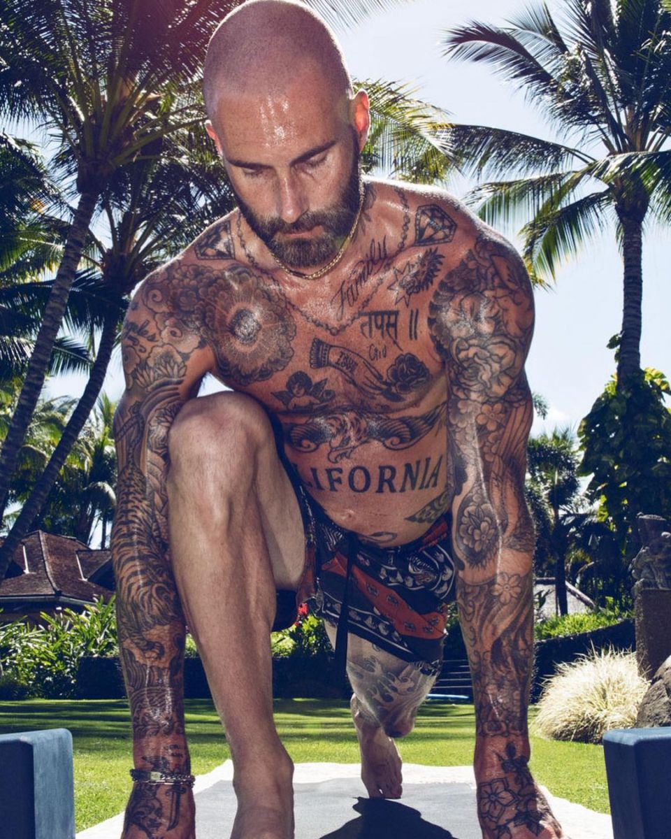 Adam Levineâ€™s tattoos displaying as he does yoga