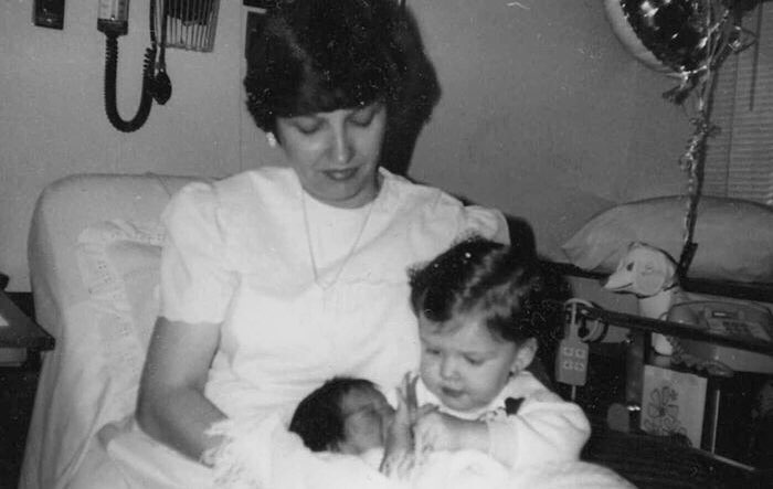 Monochrome picture of Arlette, her mother, and her little sister