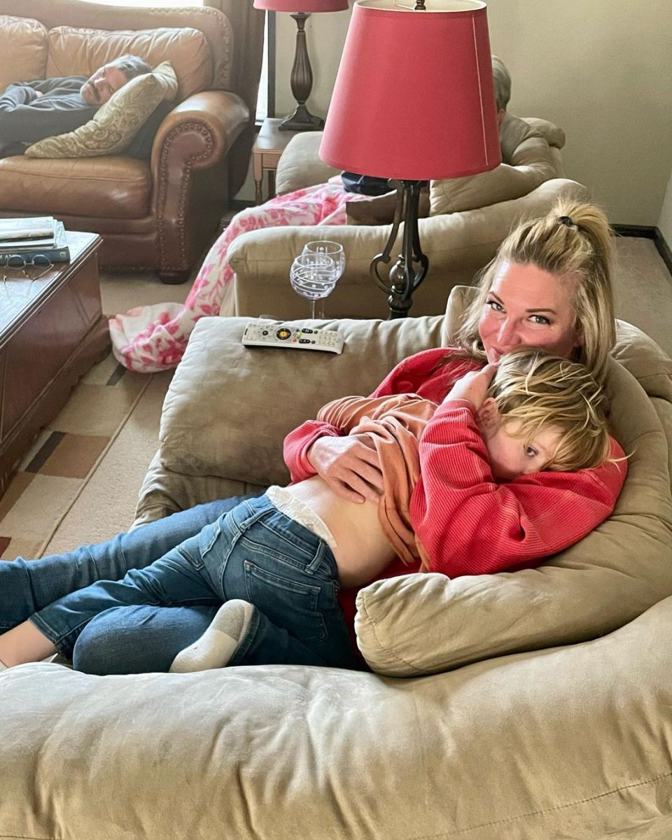 Brandon's former wife, Jen Hatmaker, lying on the couch with her son