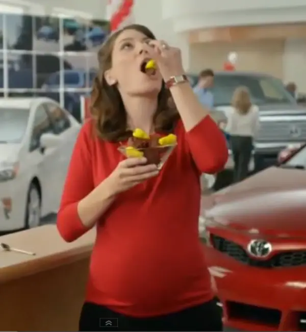 Caption: Laurel Coppock with a baby bump in one of the Toyota commercials. 