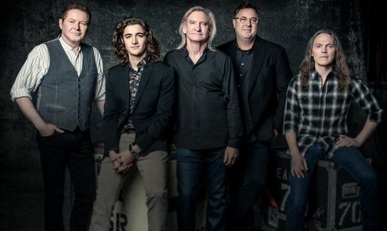 Deacon Frey (second from left) posing with the members of The Eagles