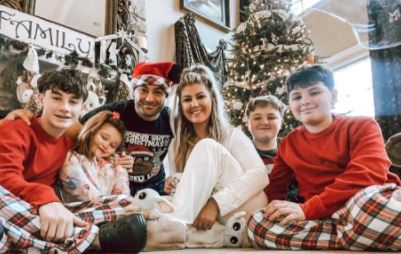 Eddie Alvarez posing for Christmas picture with his wife and kids 