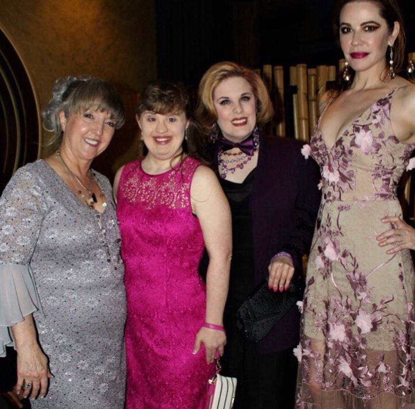 Jamie Brewer (second from left) posing with notable personalities at the premiere of the film Turnover 