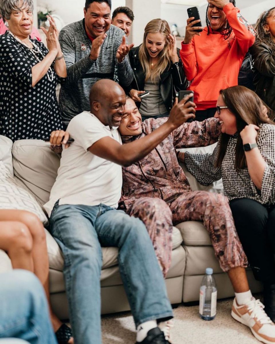 Kellen Mond celebrating his NFL draft selection with his parents and his close ones