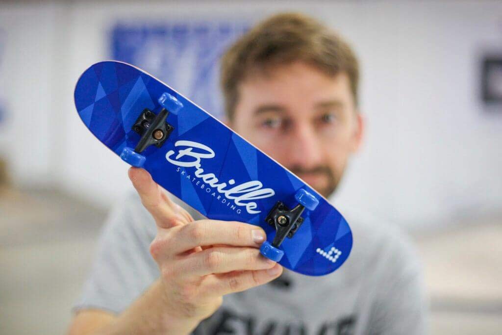 Aaron Kyro with His Braille Skateboard