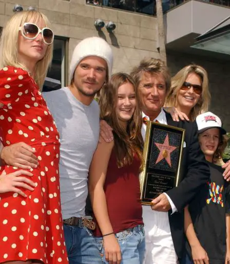 Rod posing with his kids and spouse while receiving an award 