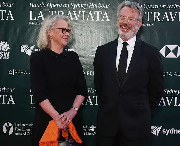 Sam Neil posing on the red carpet with his former partner Laura 