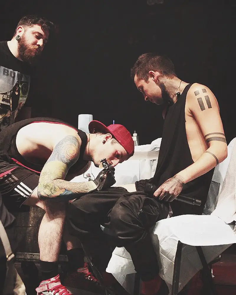 Josh Dun inking his bandmate Tyler Joseph on the stage